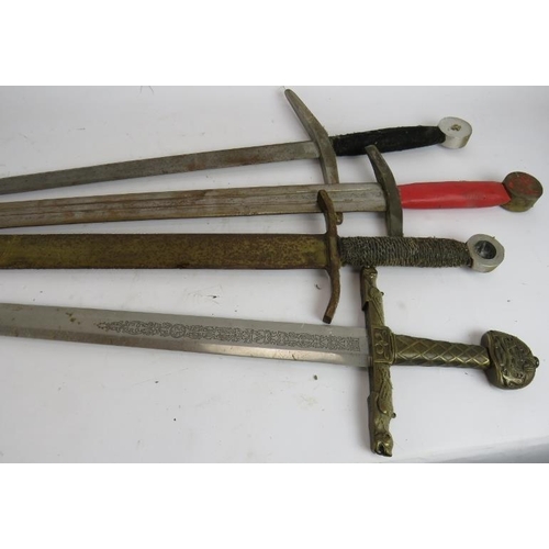 242 - Four medieval style replica swords for display or re-enactment, one with ornate bronze hilt and etch... 