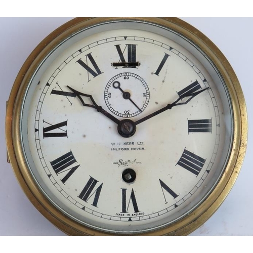 245 - A brass Sestrel ships clock with painted dial, W.H. Kerr Ltd., Milford Haven. Key present. Dial Diam... 