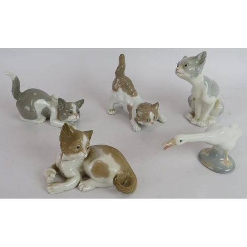 251 - Seven Lladro Spanish porcelain figures including Don Quixote, young lovers, a goose and four cats. T... 