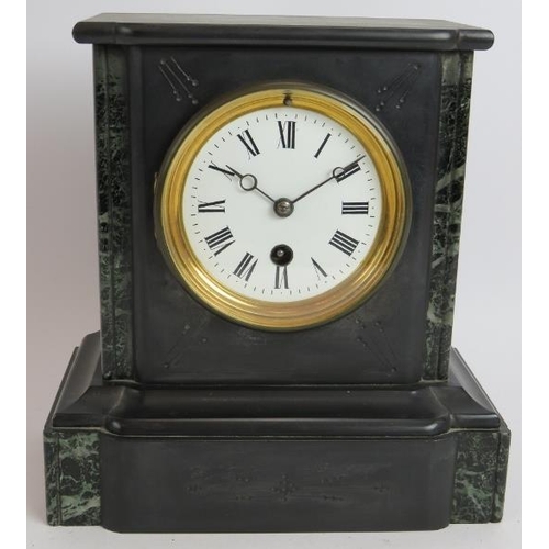 263 - A small antique slate mantel clock with enamelled dial. Key and pendulum present. Height 23cm.
Condi... 