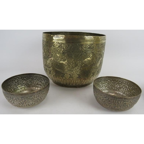 273 - A finely decorated Indo-Persian brass Jardinière, two repousséd Eastern bowls, a turned brass Chines... 