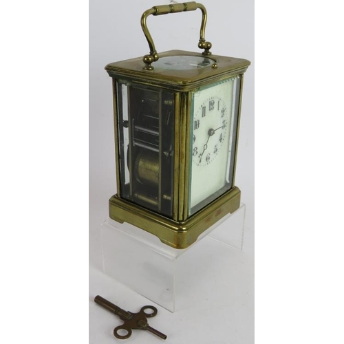 281 - A French 8 day repeating carriage clock in brass case with white dial. Overall height: 17cm. Key pre... 