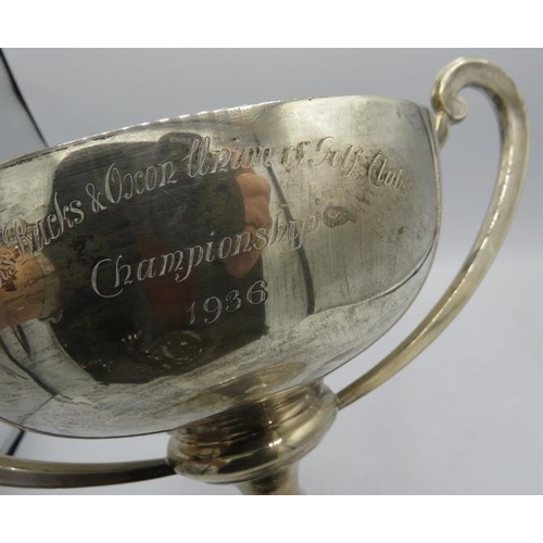 312 - A large two handled silver golfing trophy. Chester 1934. Approx: 9