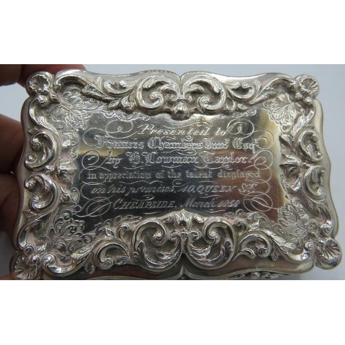 318 - A heavy Victorian silver table snuff box with presentation inscription and scrolls and flowers, with... 