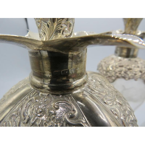 319 - A set of three Edwardian silver mounted pinched glass decanters with original silver mounted stopper... 