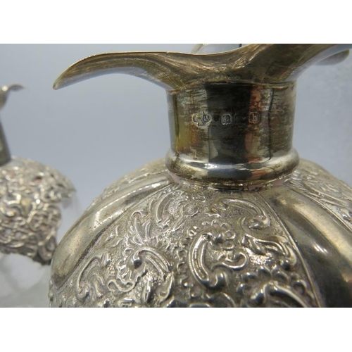 319 - A set of three Edwardian silver mounted pinched glass decanters with original silver mounted stopper... 