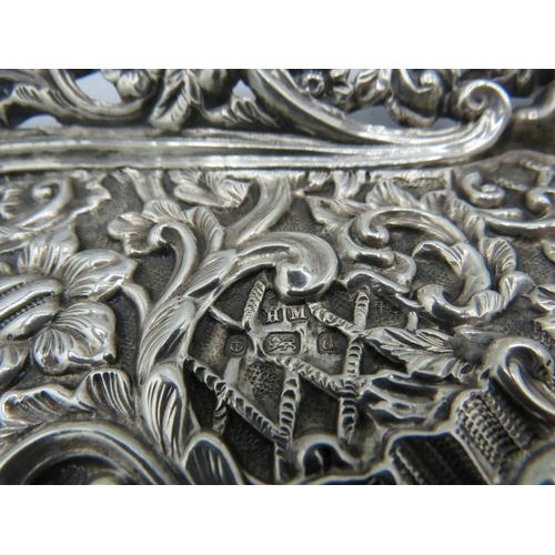 330 - A heavily embossed silver dressing table tray. Birmingham 1903. 9.4 troy oz/295 grams.
Condition rep... 