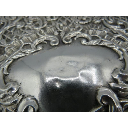 330 - A heavily embossed silver dressing table tray. Birmingham 1903. 9.4 troy oz/295 grams.
Condition rep... 