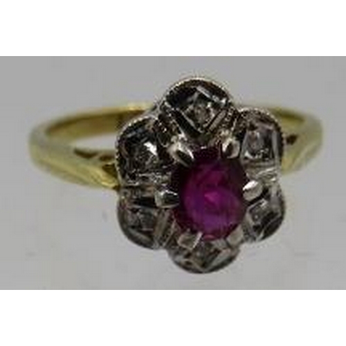 331 - An 18ct yellow and white gold ruby cluster ring. The centre ruby approx 4mm x 3mm with six small sur... 