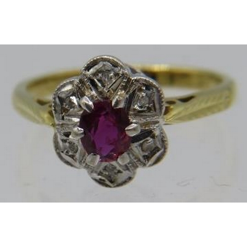 331 - An 18ct yellow and white gold ruby cluster ring. The centre ruby approx 4mm x 3mm with six small sur... 