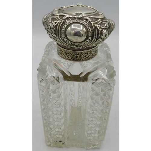 399 - A large heavy cut glass silver topped scent bottle with inner stopper. Approx: 7