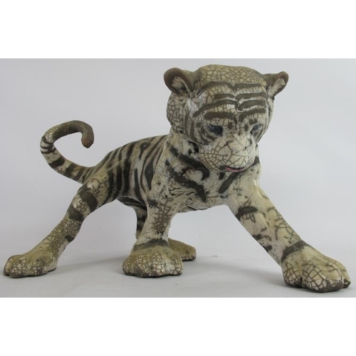 4 - A glazed pottery figure of a tiger cub by Keza Rudge, signed. Length 41cm. Height 23cm.
Condition re... 