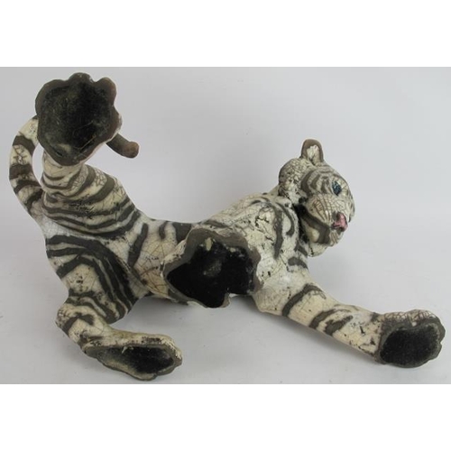 4 - A glazed pottery figure of a tiger cub by Keza Rudge, signed. Length 41cm. Height 23cm.
Condition re... 