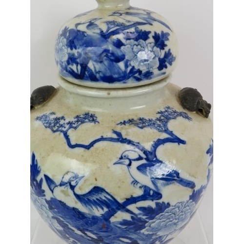 42 - A 19th century Chinese blue and white crackle ware porcelain vase and cover in the Kangxi style pain... 