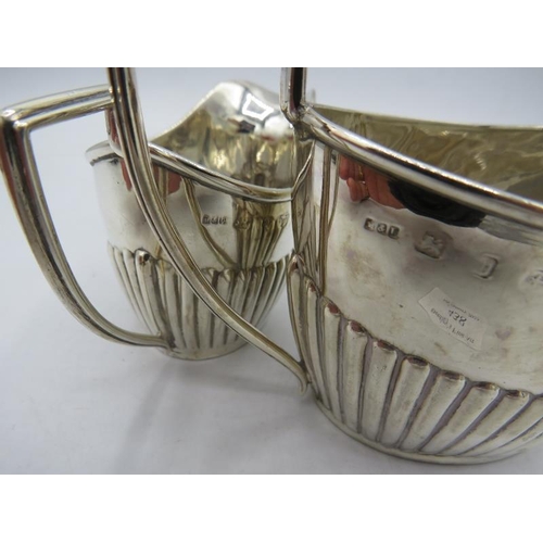 438 - A silver jug and matching sugar bowl with half fluting decoration. Birmingham 1878. 5.2 troy oz/162 ... 