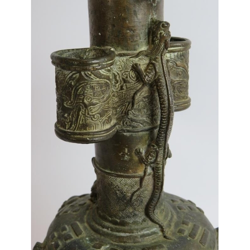 50 - An antique Chinese bronze vase in the Archaic style decorated with dragons and with lion mask handle... 