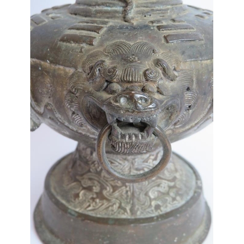 50 - An antique Chinese bronze vase in the Archaic style decorated with dragons and with lion mask handle... 