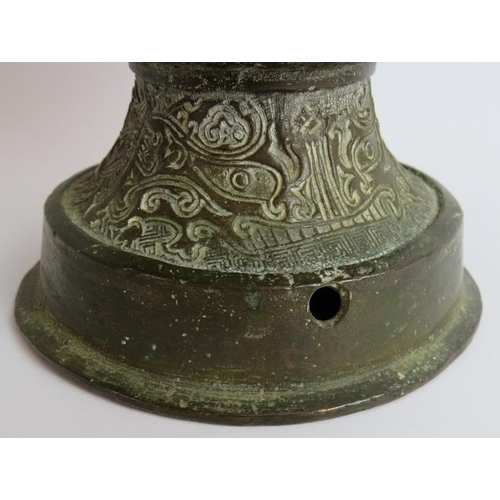 50 - An antique Chinese bronze vase in the Archaic style decorated with dragons and with lion mask handle... 