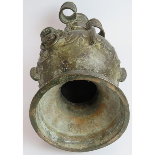 50 - An antique Chinese bronze vase in the Archaic style decorated with dragons and with lion mask handle... 