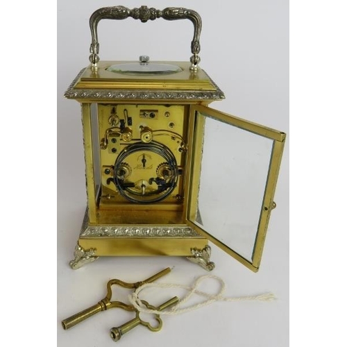 54 - An ornate gilt and silver plated brass Repeater carriage clock with strike and alarm movement, keys ... 