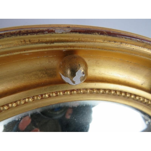 56 - A circular gilt framed convex mirror with bead decoration, diameter: 40cm.
Condition report: Some gi... 