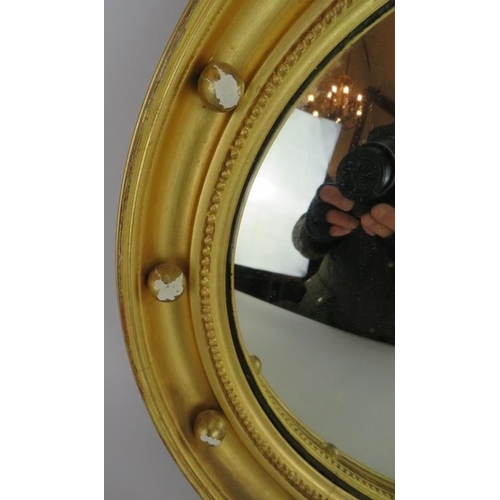 56 - A circular gilt framed convex mirror with bead decoration, diameter: 40cm.
Condition report: Some gi... 