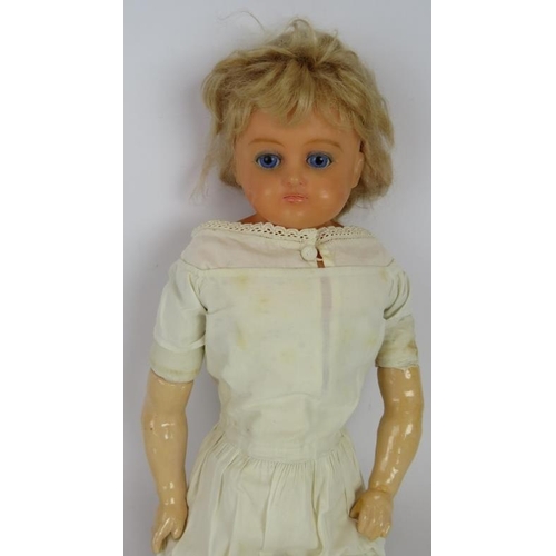 62 - An antique wax headed doll with hand painted features. Straw filled body and plaster limbs. Overall ... 