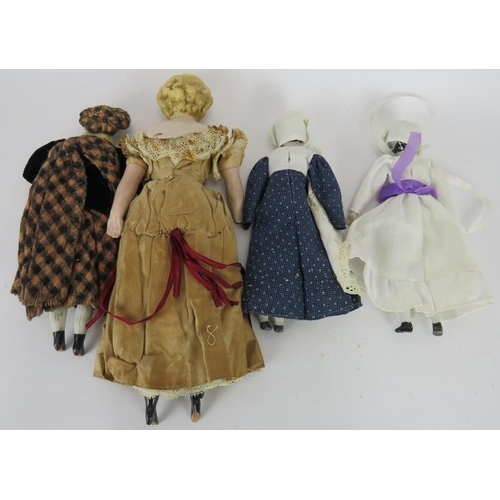 63 - Four 19th century porcelain headed dolls, one in silk dress, one in Highland dress. Tallest: 30cm. (... 