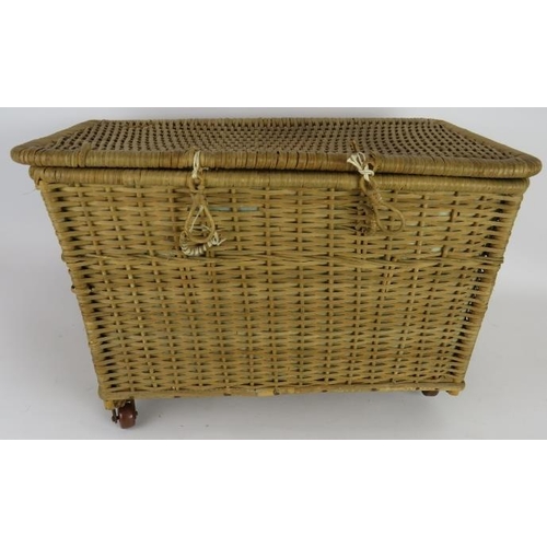 69 - A early 20th century silk lined basket with lift out tray containing 9 period dolls dresses and 6 it... 