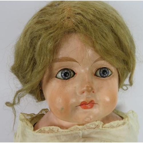 73 - A large antique wax faced doll with leather body (76cm) and two smaller bisque headed dolls. Plus so... 