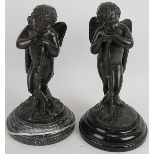 86 - A pair of contemporary bronze cupid figures mounted on black marble bases. Signed indistinctly. Heig... 