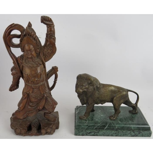 91 - A Chinese root wood carving of a warrior, three bronze eastern ministrels, a bronze lion on green ma... 