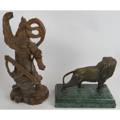 91 - A Chinese root wood carving of a warrior, three bronze eastern ministrels, a bronze lion on green ma... 