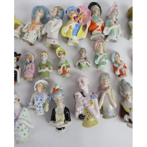 97 - A collection of porcelain doll brush tops of varying design, mostly continental. (QTY).
Condition re... 