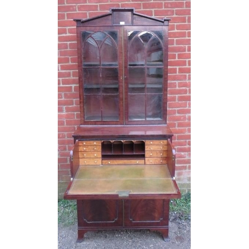 709 - A fine Regency Period tall library secretaire bookcase, the astral glazed doors opening onto two hei... 