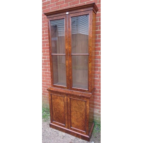 710 - A Victorian burr walnut tall display bookcase, the glazed doors opening onto four height adjustable ... 