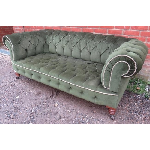 711 - A Victorian Chesterfield sofa, upholstered in green velvet buttoned material with braided rope trim,... 