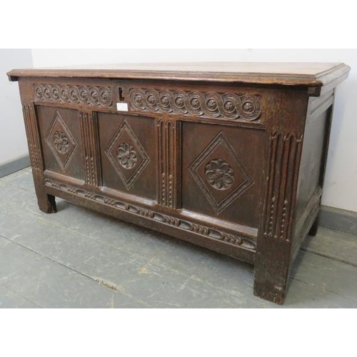 714 - A 17th century panelled oak coffer of small proportions, with relief carved frieze and diamond carvi... 