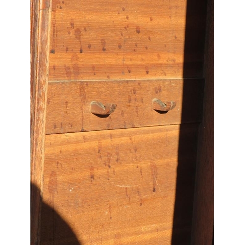 718 - A large 18th century Welsh oak livery cupboard, the inlaid cornice featuring a central butterfly, ab... 