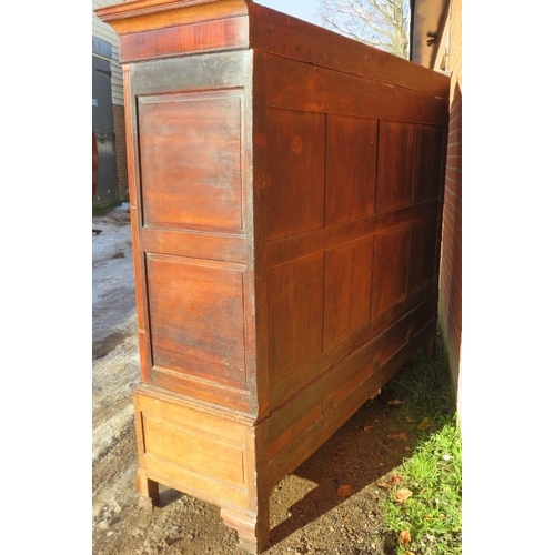 718 - A large 18th century Welsh oak livery cupboard, the inlaid cornice featuring a central butterfly, ab... 