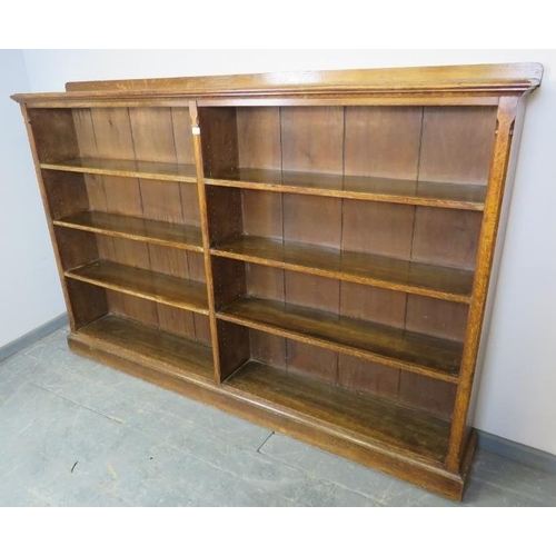 720 - A large Victorian Gothic Revival medium oak low open bookcase of six height adjustable shelves, on a... 