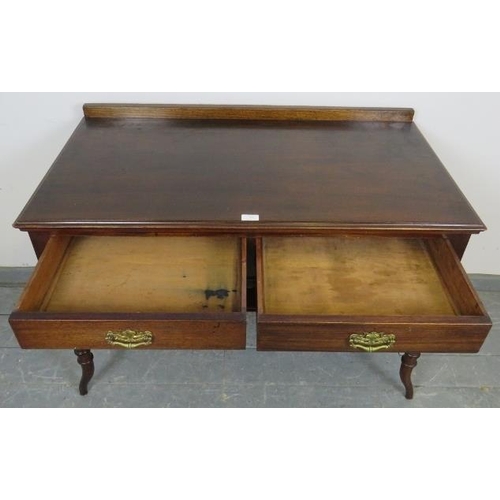 722 - An Edwardian mahogany writing table, housing two short drawers with fancy brass handles, on tapering... 