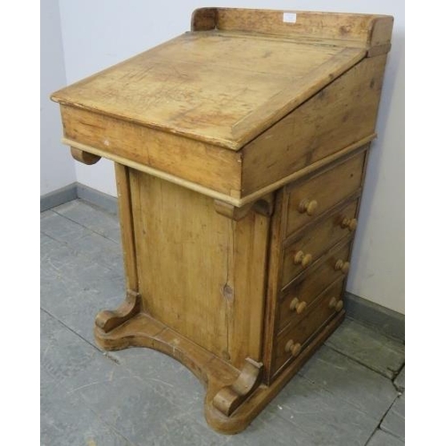 723 - A Victorian pine Davenport, the lid opening onto a fitted interior, above four long drawers and four... 