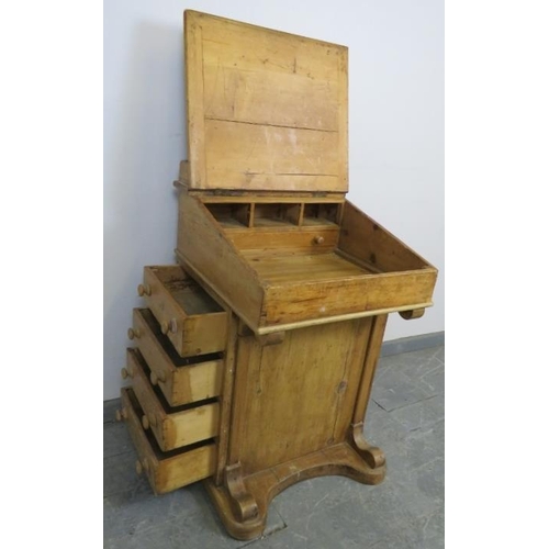 723 - A Victorian pine Davenport, the lid opening onto a fitted interior, above four long drawers and four... 