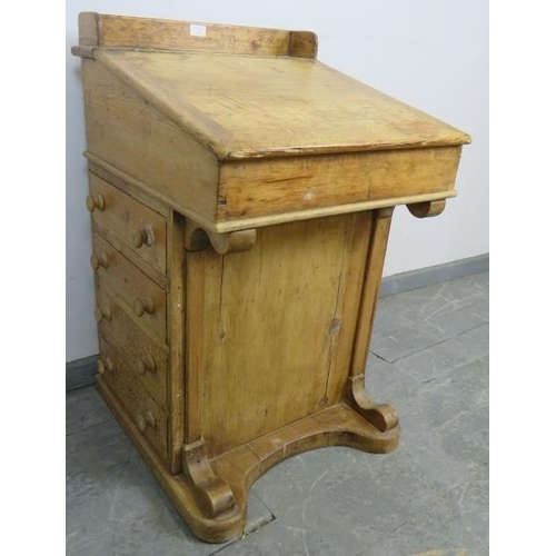 723 - A Victorian pine Davenport, the lid opening onto a fitted interior, above four long drawers and four... 