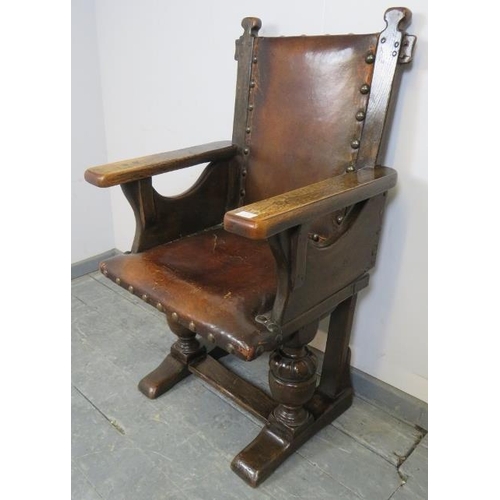 729 - A 19th century oak Jacobean Revival armchair, upholstered in burgundy leather with large brass boss ... 