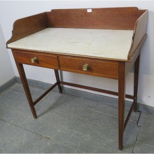 734 - An Edwardian mahogany marble topped washstand with ¾ gallery, above two short drawers with pressed b... 