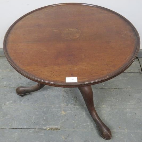 740 - A Georgian mahogany low circular occasional table, on a turned column with splayed tripod supports a... 