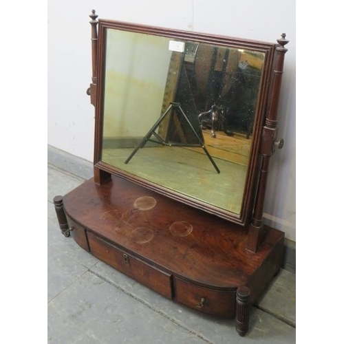 750 - A George III mahogany swing vanity mirror, on a bow-fronted box base housing three drawers, flanked ... 