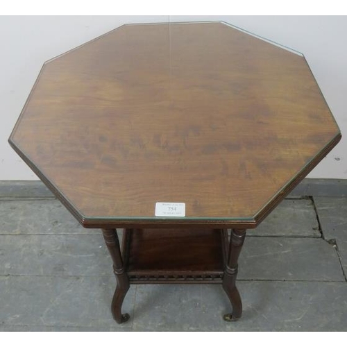 754 - An Edwardian mahogany octagonal two-tier occasional table, featuring arcaded gallery, on outswept oc... 